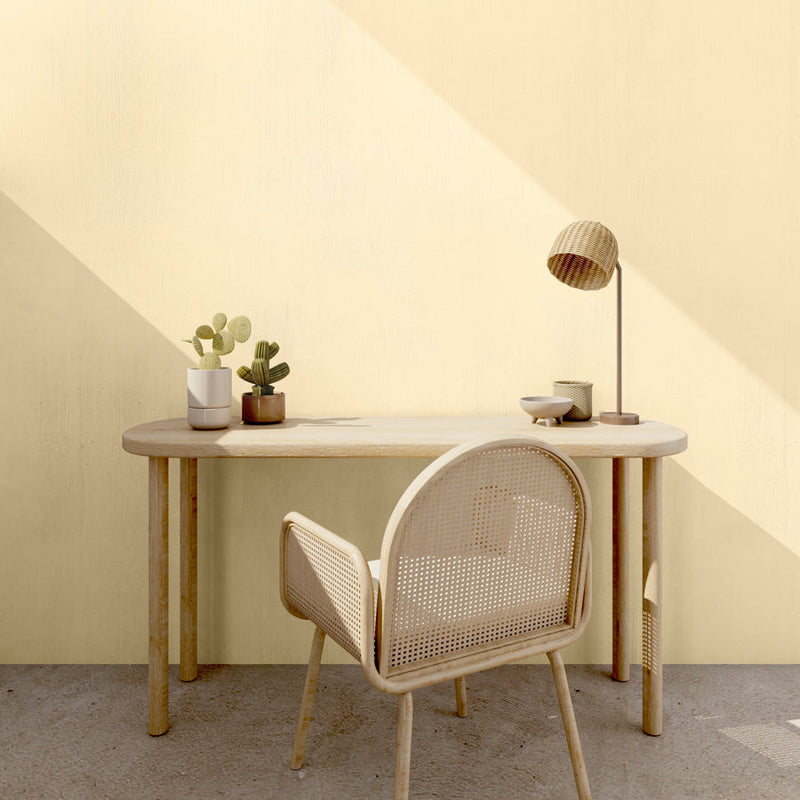 A small table in front of wall decorated with Spring Flowers, a pastel yellow paint from Zhoosh Paints.