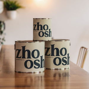 Zhoosh paint cans on a table