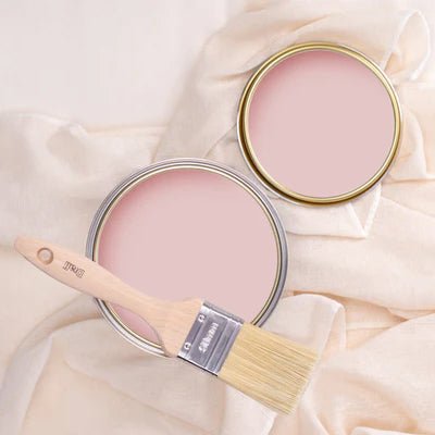 Tins of Rhythmic Pink paint on a pink background