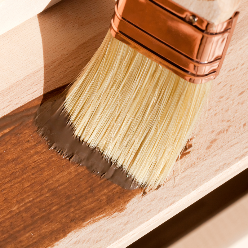 paintbrush varnishing wooden furniture