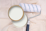 Tins of Mellow White paint with a paint roller