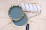 Tins of Reggae Blue paint with a paint roller