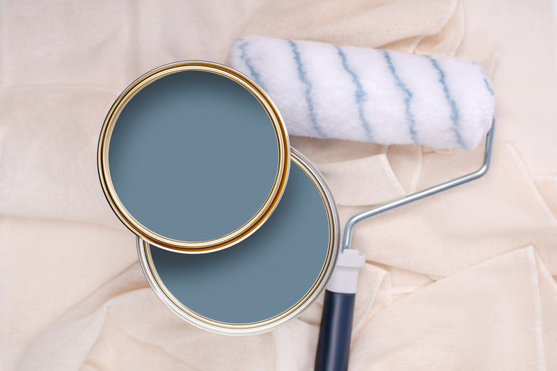 Tins of Reggae Blue paint with a paint roller