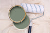 Tins of Reggae Green paint with a paint roller