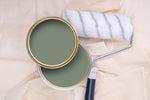 Tins of Reggae Green paint with a paint roller