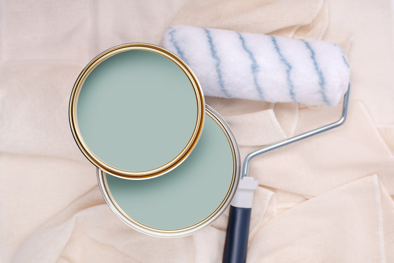 Tins of Smooth Blue paint with a paint roller