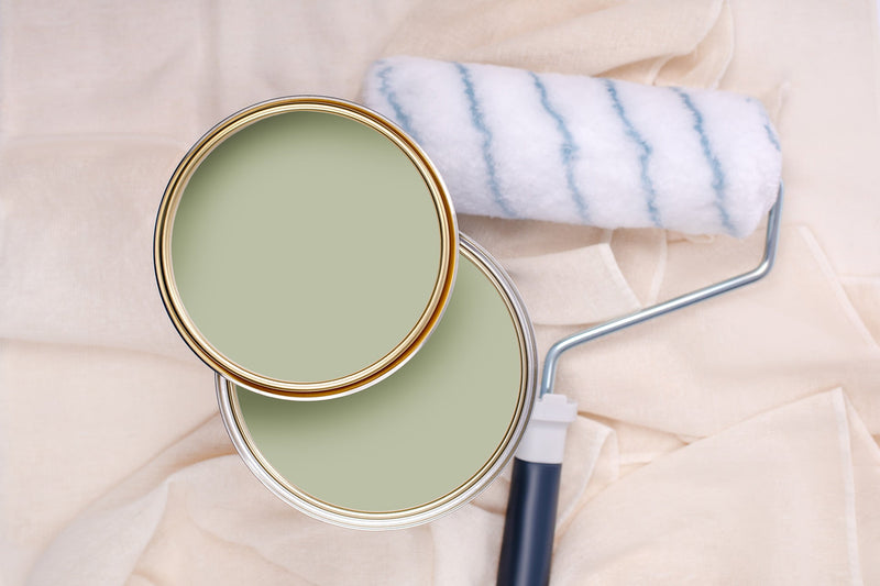 Tins of Smooth Green paint with a paint roller