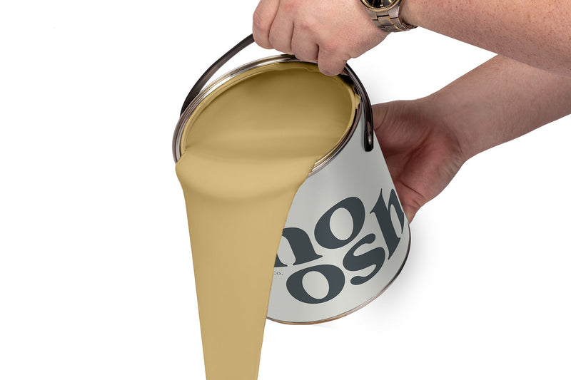 A person pours Rhythmic Yellow paint from a tin