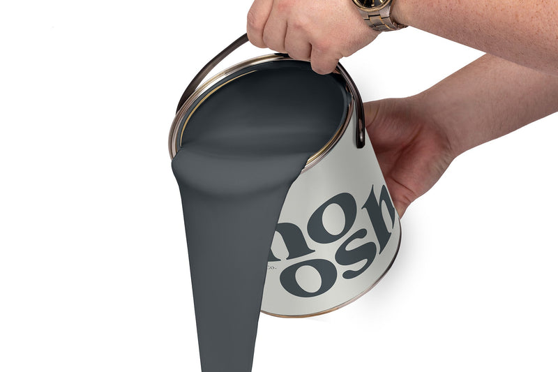 A person pours Rock Grey paint from a tin