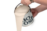 A person pours Country Pink paint from a tin