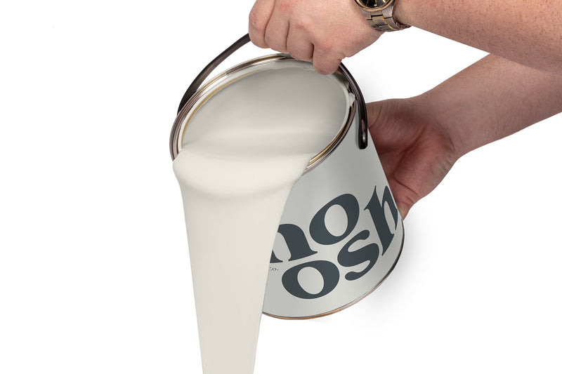 A person pours Country White paint from a tin