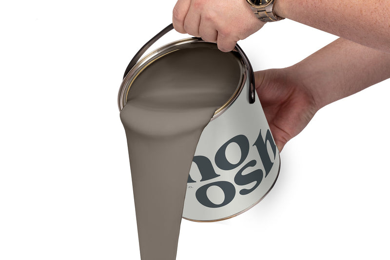 A person pours Hip Hop Grey paint from a tin