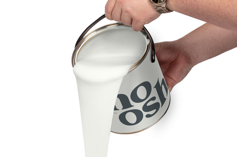 A person pours Mellow White paint from a tin