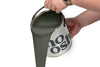 A person pours Pop Green paint from a tin