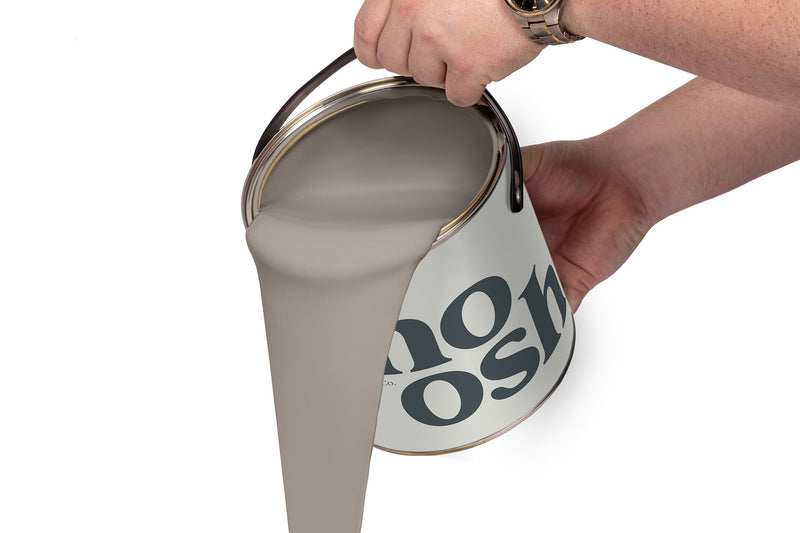 A person pours Pop Grey paint from a tin