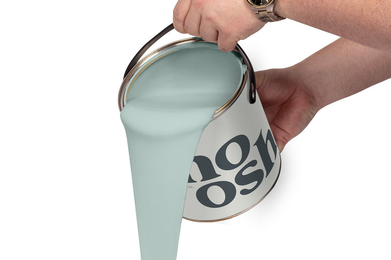 A person pours Smooth Blue paint from a tin