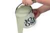 A person pours Smooth Green paint from a tin