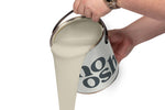 A person pours Soulful Beige paint from a tin